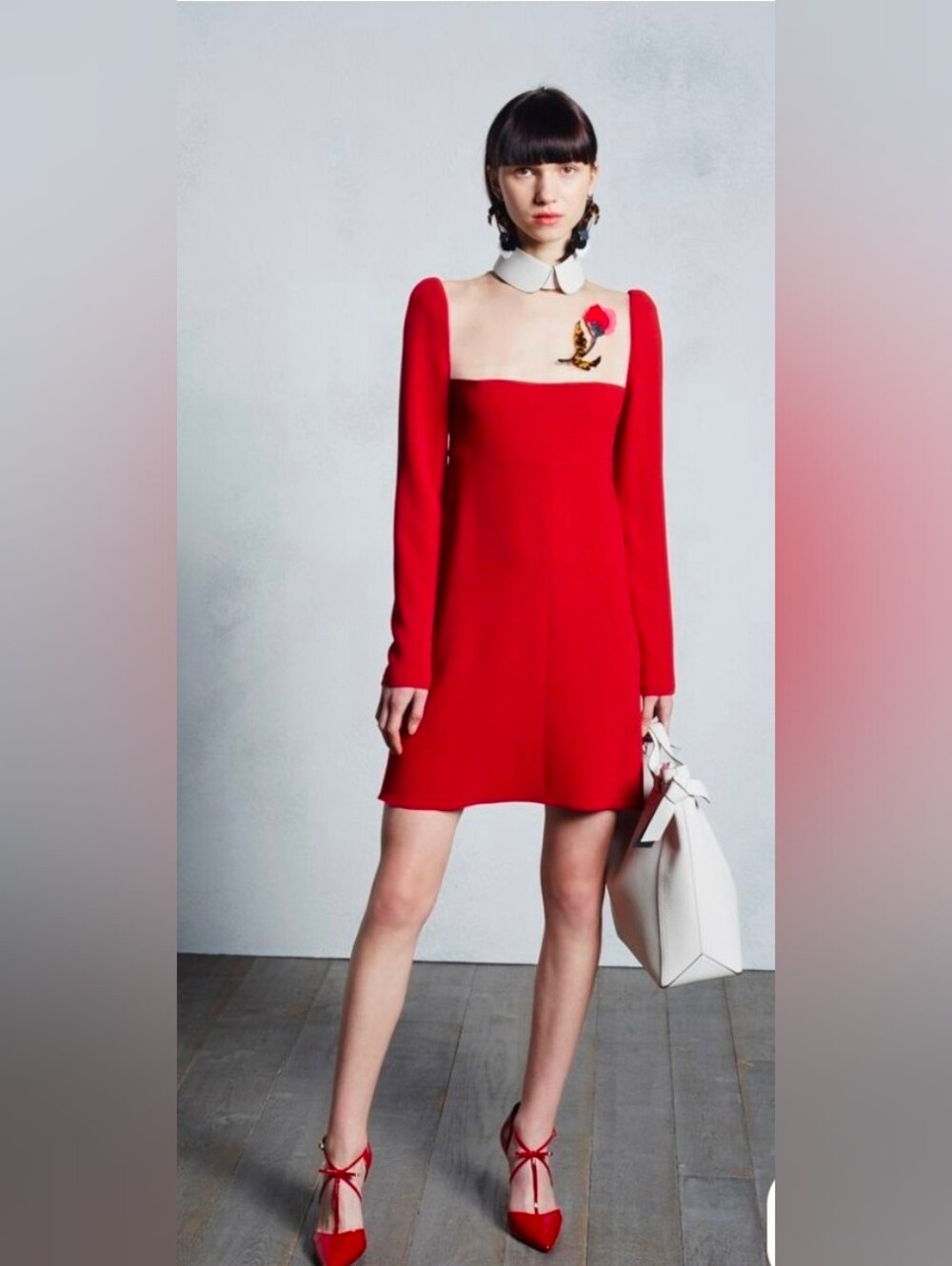 vibrant red long-sleeve dress with a white Peter Pan collar and an embroidered